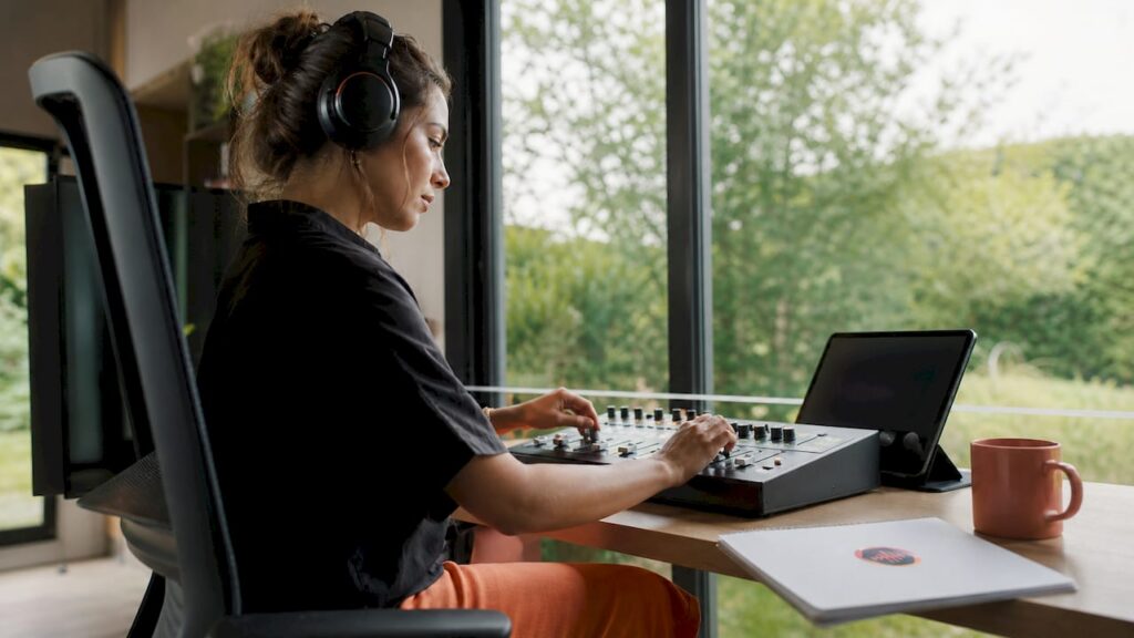 Audio engineer adjusting mix revisions in home studio