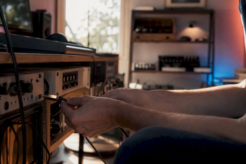 Hands unplugging cables in a recording studio