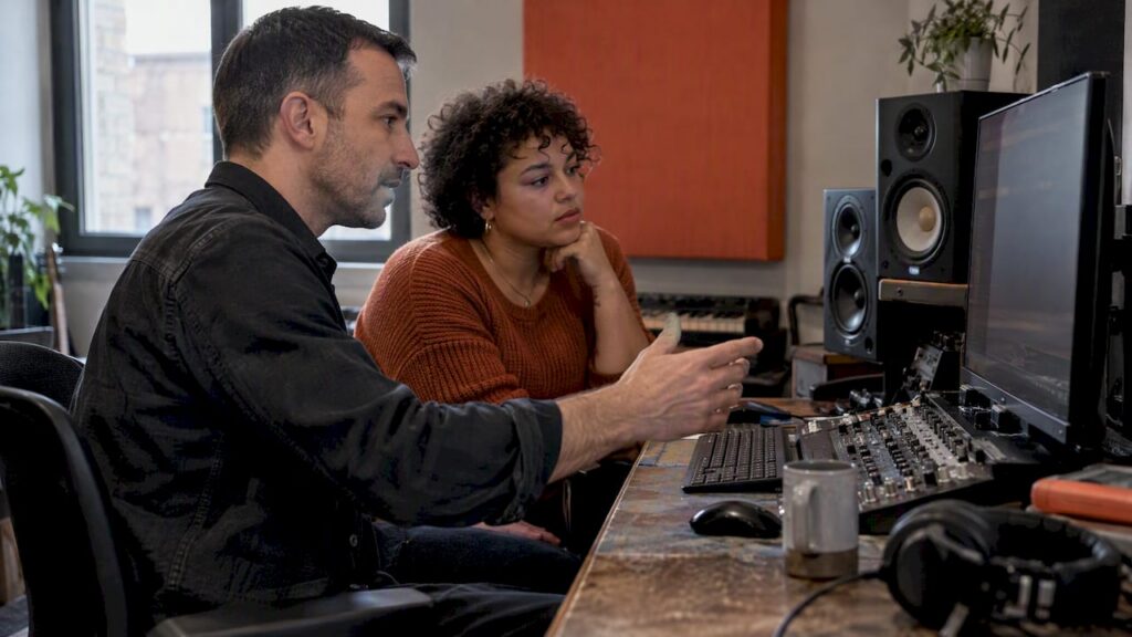 Engineer and artist reviewing an audio mix