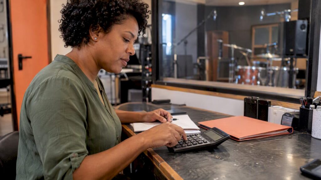 Studio owner calculating an audio rush fee
