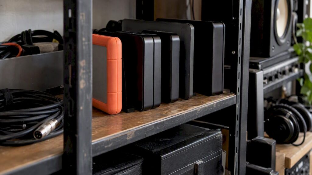 Organized external drives on a studio shelf
